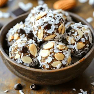 - 1 cup rolled oats - 1/2 cup almond butter - 1/4 cup honey or maple syrup - 1/4 cup unsweetened shredded coconut - 1/4 cup dark chocolate chips - 1/2 cup chopped almonds - 1/2 teaspoon vanilla extract - Pinch of sea salt You need simple and healthy ingredients for these Almond Joy Energy Bites. Each item adds a special touch. Rolled oats are the base. They give a nice texture and help keep you full. You can use any brand you like. Almond butter is the star. It adds creaminess and a nutty flavor. Make sure it's smooth for easy mixing. Honey or maple syrup brings sweetness. You can pick either based on your taste. Both work well. Unsweetened shredded coconut gives that tropical touch. It adds chewiness and a hint of coconut flavor. Dark chocolate chips offer a rich taste. They balance sweetness and give a little indulgence. Chopped almonds add crunch. They also boost the healthy fats in the bites. Vanilla extract enhances all the flavors. It brings everything together in a lovely way. A pinch of sea salt is key. It boosts the other flavors, making every bite delicious. Gather these ingredients, and you're set for a tasty and healthy snack! Start by adding 1 cup of rolled oats into a large mixing bowl. Next, add 1/2 cup of almond butter and 1/4 cup of honey or maple syrup. Use a spatula to mix these ingredients well. Make sure you have no dry oats left. This step ensures a nice, smooth base. After that, it's time to add the fun stuff! Mix in 1/4 cup of unsweetened shredded coconut, 1/4 cup of dark chocolate chips, and 1/2 cup of chopped almonds. Don't forget the 1/2 teaspoon of vanilla extract and a pinch of sea salt. Stir until everything is blended and evenly distributed. You want every bite to taste great. Now that your mixture is ready, take small portions and roll them into balls. Aim for 1 inch in diameter. If the mixture is sticky, dampen your hands with a little water. This trick makes it easier to roll the bites without the mixture sticking to your hands. Once you roll all the bites, arrange them on a parchment-lined baking sheet. Place them in the fridge for at least 30 minutes. This chilling time helps the bites firm up and hold their shape. After chilling, transfer the bites to an airtight container. Store them in the fridge for up to a week. If you want to keep them longer, freeze them. This way, you always have a tasty snack ready to enjoy! To make your Almond Joy Energy Bites even better, try adding different flavors. You can mix in dried fruits like cherries or apricots. For a nutty twist, consider using cashew butter instead of almond butter. Balance sweetness by adjusting honey. You might want to use less if you add sweet fruits. This keeps the bites rich but not overly sweet. Sticky mixtures can be a challenge. To handle them, wet your hands slightly before rolling the bites. This helps prevent the mix from sticking to your fingers. For efficiency, use a cookie scoop. It helps you form uniform bites quickly. Plus, you’ll save time and have neat energy bites. Serving your bites can be fun! Place them in a small bowl or a jar for a cute display. You can sprinkle extra coconut on top for a nice touch. Drizzling melted dark chocolate over the bites adds visual appeal. This makes them look even more inviting and delicious. {{image_4}} To make these Almond Joy Energy Bites vegan, swap honey for maple syrup. Maple syrup adds sweetness without any animal products. You can also use agave nectar or brown rice syrup. These choices work well in this recipe. All ingredients can be gluten-free. Make sure your oats are certified gluten-free. This ensures there is no cross-contamination. You can also use sunflower seed butter if you have a nut allergy. It adds a nice flavor too. Feel free to add dried fruits like cranberries or raisins. They add chewiness and extra sweetness. You can also toss in seeds like chia or flaxseeds for nutrition. If you want a different taste, try using cashew or peanut butter. Each nut butter brings a unique flavor to the bites. To keep Almond Joy Energy Bites fresh, store them in the refrigerator. Place them in an airtight container to prevent them from drying out. If you want to store them longer, freezing is a great option. Just make sure to wrap them in plastic wrap, then put them in a freezer-safe bag. These energy bites stay fresh for up to a week in the fridge. If frozen, they can last up to three months. Watch for signs of spoilage like an off smell or changes in texture. If they feel dry or crumbly, it’s best to toss them. Use glass jars or plastic containers with tight lids for storage. These options keep air out, which helps maintain freshness. Avoid using paper or cardboard, as they do not provide a good seal. Almond Joy Energy Bites can last up to one week in the fridge. Store them in an airtight container. If you want them to last longer, freeze them. They can stay fresh for three months in the freezer. Just let them thaw before you eat. Yes, you can use other nut butters! Peanut butter or cashew butter work well. Each nut butter will give a different taste. Make sure to choose one you like. The texture will also change a bit, but it will still taste great. Absolutely! These energy bites are perfect for kids. They are healthy and fun to eat. You can even get kids involved in making them. Just watch the size of the bites for younger kids. They make a great snack or a treat! To make the bites less sweet, reduce the honey or maple syrup. You can cut it by half or use unsweetened nut butter. Adding more oats or coconut can also help balance the sweetness. Taste the mix and adjust to your liking. Yes, you can replace dark chocolate chips! Use milk chocolate or white chocolate instead. You can also skip the chocolate and add more nuts or dried fruits. Each option will change the flavor but keep it delicious. These energy bites are simple to make and tasty. You need just a few healthy ingredients like oats, almond butter, and dark chocolate. After you mix, roll them into balls and chill. Feel free to add your favorite flavors or make them vegan and gluten-free. Store them in airtight containers to keep them fresh. Enjoy these bites as a healthy snack for you or your kids. You now have the tools to create a delicious energy boost anytime.