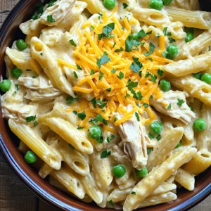 - 4 boneless, skinless chicken breasts - 1 packet ranch seasoning mix - 1 can (10.5 oz) cream of chicken soup - 1 cup chicken broth - 1 cup heavy cream - 8 oz pasta (penne or rotini) - 1 cup frozen peas - 1 cup shredded cheddar cheese - Salt and freshly ground black pepper to taste - Fresh parsley, chopped (for garnish) - Slow cooker - Large pot - Mixing bowls - Forks for shredding chicken When I make Slow Cooker Creamy Ranch Chicken Pasta, I love using fresh ingredients. Fresh chicken breasts work best for flavor. The ranch seasoning mix gives a tasty twist. It is my go-to for a rich flavor. A can of cream of chicken soup adds creaminess. Chicken broth keeps the dish moist and tasty. Heavy cream makes it extra rich. For pasta, I prefer penne or rotini. Both hold the sauce well. Frozen peas add color and nutrition. Shredded cheddar cheese gives a nice cheesy finish. You can add salt and pepper for extra taste. Fresh parsley on top looks nice and adds freshness. Gather your tools too. A slow cooker is key for this recipe. A large pot is needed for boiling pasta. Mixing bowls help combine the creamy sauce. Forks are great for shredding the chicken. These ingredients and tools make this dish easy and fun. You’ll have a creamy and delicious meal ready to enjoy! First, take your four chicken breasts and lay them flat in the slow cooker. Make sure they fit nicely so they cook evenly. Next, grab a bowl and mix the ranch seasoning, cream of chicken soup, chicken broth, and heavy cream. Stir it well until it looks smooth. Once ready, pour this creamy mix over the chicken. Make sure every piece gets a good coat. Now, it’s time to set the slow cooker. Choose the low setting for 6-7 hours or the high setting for 3-4 hours. The chicken should turn out tender and juicy. About 30 minutes before serving, use two forks to shred the chicken right in the slow cooker. This way, it soaks up all the creamy goodness. While the chicken cooks, boil a large pot of salted water. Cook the pasta according to the package until it is al dente. When done, drain the pasta and set it aside. Once the chicken is shredded, mix in the cooked pasta and frozen peas. Then, sprinkle the shredded cheddar cheese on top. Stir it gently and let it sit for 10 minutes. This helps the cheese melt into the dish. Adjust the taste with salt and pepper if needed. Enjoy your creamy ranch chicken pasta! To ensure even cooking for the chicken, place the chicken breasts flat in the slow cooker. This helps them cook at the same rate. If you have a newer slow cooker, check it often. They can cook faster than older models. Adjust the cooking time based on your slow cooker model. To add more flavor, you can include spices or herbs like garlic powder or thyme. These can brighten up the dish. You can also use different types of cheese. Try mozzarella or pepper jack for a twist. Each cheese brings its own taste to the pasta. For a lovely presentation, serve the creamy ranch chicken pasta in a large bowl. This gives it a family-style feel. Garnish with chopped fresh parsley for color. You can also add extra cheese on top. This makes the dish look even more appetizing. {{image_4}} You can change up the protein in this dish. For a lighter option, use turkey instead of chicken. If you want a plant-based choice, try tofu. Both options work well with ranch flavor. For those who need dairy-free alternatives, you can swap heavy cream with coconut milk. This keeps the dish creamy without dairy. If gluten is a concern, there are many gluten-free pasta options available. Look for rice or chickpea pasta. These options hold up well in the slow cooker. You can also switch pasta shapes for fun. Rotini or farfalle adds different textures to your meal. Adding veggies can boost nutrition and flavor. Spinach is a great choice. You can add it during the last 10 minutes of cooking. Bell peppers also add color and crunch. When adding veggies, adjust the cooking time. Softer veggies need less time. For firmer ones, like carrots, add them earlier to ensure they cook through. To store leftover creamy ranch chicken pasta, let it cool first. Use an airtight container to keep it fresh. This helps prevent the pasta from drying out. You can store it in the fridge for up to three days. Be sure to label the container with the date. You can freeze this pasta dish too. Place the cooled leftovers in a freezer-safe container. Make sure to leave some space at the top for expansion. It can stay in the freezer for up to three months. When ready to eat, take it out and thaw it in the fridge overnight. To reheat, place the pasta in a pot with a little chicken broth. This keeps it from drying out. You can also use a microwave-safe dish. Cover it and heat in short bursts, stirring often. Reheating should be gentle. For the stove, use low heat and stir often. This prevents overcooking and keeps the pasta creamy. If using a microwave, heat in intervals of 30 seconds. Stir after each interval for even warmth. Enjoy your meal without losing its creamy goodness! Can I prepare Slow Cooker Creamy Ranch Chicken Pasta ahead of time? Yes, you can prep this dish ahead. Cook the chicken and sauce the night before. Store them in the fridge. In the morning, just add the pasta and peas before cooking. What can I substitute for cream of chicken soup? You can use cream of mushroom soup or a homemade white sauce. Both options will provide good creaminess. How do I make this recipe spicier? Add red pepper flakes or a dash of hot sauce to the creamy mix. This will give your dish some kick without overpowering the ranch flavor. How long does it take to cook this dish in a slow cooker? This dish takes about 6-7 hours on low or 3-4 hours on high. The chicken should be tender and easily shredded. How many servings does this recipe yield? This recipe serves about 6 to 8 people. It’s perfect for family dinners or meal prep. Is this recipe suitable for specific dietary needs? This recipe contains dairy and gluten due to the cream and pasta. You can make it gluten-free by using gluten-free pasta. How can I make this dish healthier? Use low-fat cream instead of heavy cream. You can also add more veggies like spinach or bell peppers. This boosts nutrition without losing flavor. This blog post walked you through making Slow Cooker Creamy Ranch Chicken Pasta. You learned about essential ingredients, step-by-step cooking instructions, and tips for flavor and presentation. You also found options for substitutions, storage, and reheating. Now you can confidently prepare a delicious meal that fits your tastes and dietary needs. Enjoy your cooking and share this recipe with friends and family for a cozy gathering!