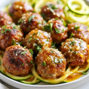 To make Keto Garlic Butter Meatballs, you need to gather some key ingredients. Here’s a clear list: - 1 pound ground beef - 1/4 cup almond flour - 1/4 cup grated Parmesan cheese - 1 large egg - 3 cloves garlic, minced - 1 teaspoon dried oregano - 1 teaspoon onion powder - 1/2 teaspoon salt - 1/4 teaspoon black pepper - 1/4 cup fresh parsley, chopped - 1/2 cup unsalted butter - 1 tablespoon olive oil - 1 teaspoon lemon juice Let’s break down these ingredients. The ground beef gives the meatballs their rich flavor. I recommend using beef with 20% fat for juiciness. Almond flour acts as a low-carb binder. It keeps everything together without adding carbs. Grated Parmesan cheese enhances the flavor and adds a nice texture. The egg is essential for binding. Fresh garlic brings a punch of taste. Dried oregano and onion powder add depth. The salt and black pepper season the meatballs perfectly. Fresh parsley not only adds color but also freshness. Unsalted butter makes the sauce rich and delicious. Olive oil is great for frying. Finally, lemon juice brightens the dish and balances the flavors. Having these ingredients ready makes the cooking process smooth. The mix of flavors will really shine in your finished dish. {{ingredient_image_2}} First, grab a large mixing bowl. Add the ground beef, almond flour, and grated Parmesan cheese. Next, crack in one large egg. Then, add the minced garlic, dried oregano, onion powder, salt, and black pepper. Use your hands or a spatula to mix everything well. Make sure all the ingredients blend evenly. This mixture will form the base of your meatballs. Now, preheat your oven to 400°F (200°C). Line a baking sheet with parchment paper. This will help keep the meatballs from sticking. Take the meat mixture and shape it into small balls, about one inch wide. Place the meatballs on the baking sheet. Make sure to leave some space between each one. This helps them cook evenly. Heat the olive oil in a large skillet over medium heat. Once the oil is hot, add the meatballs in batches. Avoid overcrowding the pan to get a nice brown on all sides. Sear the meatballs for about 5 to 7 minutes. When they turn golden brown, transfer them back to the baking sheet. In the same skillet, lower the heat to a gentle simmer. Add the unsalted butter and let it melt completely. Once it starts to bubble, stir in the lemon juice. Gently swirl the pan to mix everything well. Carefully add the browned meatballs back into the skillet. Cook for an additional 5 minutes. Turn the meatballs occasionally to ensure they soak up the rich garlic butter flavor. Finally, remove the skillet from the heat and garnish with freshly chopped parsley before serving. Keto Garlic Butter Meatballs are not just tasty; they fit great for a keto diet. Here is the breakdown of the nutrients in one serving (about 4 meatballs): - Calories: 380 - Protein: 25g - Fat: 30g - Carbohydrates: 4g These meatballs provide a good balance of protein and fat while keeping carbs low. This is key for anyone on a keto diet. These meatballs are perfect for a low-carb lifestyle. They use almond flour instead of bread crumbs. This keeps the carb count low while still providing a nice texture. The combination of ground beef and cheese adds healthy fats. This helps you feel full without loading up on carbs. Using fresh garlic and herbs makes them tasty without adding carbs. Plus, with only 4 grams of carbs per serving, you can enjoy these meatballs while staying in your keto goals. Pro Tips Use Fresh Ingredients: Always opt for fresh garlic and herbs to enhance the flavor of your meatballs. Fresh ingredients can significantly elevate the taste compared to dried or pre-packaged options. Don’t Overmix: When combining the ingredients, be careful not to overmix the meat mixture, as this can lead to tough meatballs. Mix just until everything is combined. Experiment with Spices: Feel free to add your favorite spices or herbs to the mixture, such as basil or thyme, to customize the flavor profile of your meatballs. Rest Before Serving: Allow the meatballs to rest for a few minutes after cooking. This will help the juices redistribute, making them more flavorful and juicy when served. {{image_4}} To make great meatballs, you need the right fat content. I recommend using ground beef with an 80/20 fat ratio. This mix keeps your meatballs juicy and flavorful. When mixing, be gentle. Over-mixing can lead to tough meatballs. Use your hands or a spatula to combine the ingredients just until mixed. You can boost flavor with extra herbs and spices. Try adding fresh basil or thyme for a new twist. A pinch of red pepper flakes can add a nice kick. You can also experiment with smoked paprika for a deeper taste. Don’t hesitate to get creative; cooking is all about personal touch! You can choose between baking and frying your meatballs. Baking is simple and creates a crisp outer layer without extra fat. Preheat your oven to 400°F (200°C) for best results. If you prefer frying, use a little olive oil. This method gives a nice brown crust. Just be careful not to crowd the pan to get that perfect sear. You can switch up the protein in these meatballs. Ground turkey, chicken, or pork work great. Each option gives a new flavor and texture. Ground turkey is leaner but still tasty. Chicken offers a mild flavor, while pork adds a rich, juicy bite. Choose what you love best or what you have on hand. Adding cheese or veggies can elevate your meatballs. Mix in shredded cheese for extra creaminess. Try mozzarella for a melty surprise or cheddar for a sharp kick. You can also add finely chopped veggies like bell peppers or spinach. These will add color and nutrition without extra carbs. Experiment with your favorites to make these meatballs uniquely yours. If you need dairy-free or egg-free options, you can easily adjust this recipe. For a dairy-free version, skip the cheese and use a nut or seed-based alternative. To bind the meatballs without eggs, use flaxseed meal or chia seeds mixed with water. This keeps the meatballs firm and delicious. Making these changes allows everyone to enjoy this dish, no matter their diet. To store leftovers, let the meatballs cool first. Place them in an airtight container. Keep them in the fridge for up to four days. Make sure to seal the container tightly to prevent drying out. You can also layer them with parchment paper for better freshness. Yes, you can freeze the meatballs. They freeze well and are great for meal prep. Place cooled meatballs in a single layer on a baking sheet. Freeze them for about one hour. Then, transfer them to a freezer bag. They last for up to three months in the freezer. For a keto-friendly side, consider these options: - Spiralized zucchini noodles - Cauliflower rice - A fresh mixed green salad - Roasted broccoli or asparagus These sides complement the meatballs and keep your meal low in carbs. Reheating meatballs can be easy. Use these methods: - Microwave: Place meatballs on a plate and cover them. Heat for 1-2 minutes, checking often. - Oven: Preheat to 350°F (175°C). Place meatballs on a baking sheet and heat for 10-15 minutes. - Skillet: Add meatballs to a skillet over low heat. Stir until warmed through. These methods keep the meatballs juicy and delicious. In this post, we covered how to make delicious Keto Garlic Butter Meatballs. I shared the right ingredients, simple steps for preparation, and tips for perfecting your dish. You learned about different protein options and ways to adapt the recipe for various diets. Remember, experimenting with flavors can enhance your meal. Enjoy cooking and savoring these meatballs, whether for a family dinner or meal prep. With practice, you’ll master this easy and tasty recipe in no time.