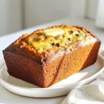 - 4 ripe bananas - 1/3 cup unsalted butter - 1 teaspoon pure vanilla extract - 1 teaspoon baking soda - Generous pinch of salt - 3/4 cup granulated sugar (or 1/2 cup for lighter sweetness) - 1 large egg - 1 cup all-purpose flour - 1/2 cup semi-sweet chocolate chips (optional) - 1/2 cup nuts (walnuts or pecans, optional) For my TikTok banana bread, choose ripe bananas. They should have brown spots. These bananas will give the bread a sweet taste. Use unsalted butter, so you can control the salt. Pure vanilla extract adds a rich flavor. Baking soda helps the bread rise. A pinch of salt brings out the sweetness. Granulated sugar is the main sweetener. You can use less sugar if you want a lighter taste. One large egg binds the mix together. All-purpose flour gives the bread structure. Optional chocolate chips and nuts add texture and flavor. If you like chocolate, add the chips. For crunch, fold in nuts. These ingredients work together to create a moist, tasty loaf. Prepare your kitchen with these items before you start. This will make the process smooth and fun! - Preheat oven to 350°F (175°C). - Grease a 9x5 inch loaf pan with butter or spray. - In a big bowl, combine melted butter and mashed bananas. - Add a beaten egg, vanilla extract, and sugar. Stir until smooth. - Mix in baking soda and salt. - Gradually fold in flour. Be gentle to keep lumps. - If you like, fold in chocolate chips and nuts. Make sure they spread evenly. - Pour the batter into the loaf pan. - Bake for 60-65 minutes. A toothpick should come out clean. - Let the bread cool in the pan for 10 minutes. - Move it to a wire rack to cool completely. This easy guide will help you make the best TikTok banana bread! To make your banana bread fluffy, avoid over-mixing the batter. Mix just until you see no flour streaks. A few lumps are okay! For testing doneness, use a toothpick. Insert it into the center of the bread. If it comes out clean or with a few moist crumbs, your bread is ready. You can add spices like cinnamon or nutmeg to boost flavor. Chopped nuts, like walnuts or pecans, add a nice crunch. For serving, try melting butter on warm slices. A drizzle of honey can add sweetness too. Pair your banana bread with coffee or tea for a cozy treat. Always use ripe bananas for the best taste. Unripe bananas may make your bread dense and less sweet. Also, grease your pan well. This step helps the bread come out easily after baking. Skipping this can lead to a messy cleanup! {{image_4}} You can make banana bread healthier in a few ways. First, swap all-purpose flour for whole wheat flour. This adds fiber and nutrients. If you want less sugar, reduce the sugar to 1/2 cup. You still get good taste without so much sweetness. For vegan options, replace the egg with 1/4 cup of applesauce. Use coconut oil or vegan butter instead of regular butter. These changes keep the bread moist and tasty. If you want to change the flavor, try adding dried fruits like raisins or cranberries. These add sweetness and texture. You can also add a teaspoon of cinnamon for a warm taste. Instead of chocolate chips, use peanut butter chips for a nutty twist. This makes the bread a bit different yet delicious. You don’t have to stick to one size. You can make mini loaves or muffins instead. For mini loaves, bake for about 30-35 minutes. If you make muffins, check them after 20 minutes. Adjust the baking time based on the size you choose to ensure they cook evenly. This way, you can serve them at parties or enjoy a quick snack! To keep your banana bread fresh, wrap it well. Use plastic wrap or aluminum foil to cover it. This helps keep moisture in and air out. Store it at room temperature for up to three days. If you need it to last longer, put it in the fridge. The cold slows down spoilage but may dry it out slightly. Freezing banana bread is easy and smart. First, let it cool completely. Then, wrap it in plastic wrap tightly. You can also put it in a freezer bag. Press out as much air as you can. This keeps the flavor and texture nice. To thaw, take it out and leave it at room temperature. It’ll be ready to enjoy in a few hours! To ripen bananas fast, you can use a few simple tricks. - Place bananas in a brown paper bag. - Add an apple or tomato to the bag. - Keep the bag closed for a day or two. - Use the oven method: wrap bananas in foil and bake at 300°F for 15-20 minutes. These methods help release ethylene gas, speeding up the ripening. Yes, you can use frozen bananas! - Thaw bananas in the fridge or at room temperature. - Once thawed, mash them well before adding to the mix. - You may need to drain some excess liquid. Frozen bananas work great in banana bread. If your banana bread turns out dense, here are reasons and fixes. - You may have over-mixed the batter. - Ensure you use ripe bananas for natural sweetness. - Check that your baking soda is fresh. - Add a bit more flour if the batter is too wet. These tips can help achieve a lighter texture. Banana bread can last quite a while if stored correctly. - At room temperature, it lasts about 3-4 days. - Store in an airtight container to keep it fresh. - In the fridge, it can last up to a week. - For long-term storage, freeze it for up to 3 months. Wrap it well to maintain flavor and texture. This banana bread recipe is simple and easy to follow. You learned about essential ingredients, step-by-step instructions, and clever tips for baking. Remember to mix well but avoid overdoing it. You can also customize your banana bread with different flavors or healthier swaps. Proper storage keeps it fresh longer. With this guide, you now have everything you need to bake a delicious loaf. Enjoy sharing this treat with friends and family!