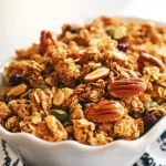 - 2 cups rolled oats - 1 cup pecans, roughly chopped - 1/2 cup almonds, roughly chopped - 1/4 cup pumpkin seeds - 1/3 cup pure maple syrup - 1/4 cup coconut oil, melted - 1 teaspoon vanilla extract - 1/2 teaspoon sea salt - 1/2 teaspoon ground cinnamon - Optional: 1/2 cup dried cranberries or raisins To make maple pecan granola clusters, you need simple, wholesome ingredients. The main ingredients are rolled oats, pecans, almonds, and pumpkin seeds. These create a crunchy base full of good nutrients. The wet ingredients add flavor and sweetness. Pure maple syrup gives it that sweet touch. Coconut oil helps bind everything together and adds richness. Vanilla extract adds a lovely aroma. Next, seasonings like sea salt and ground cinnamon balance the sweetness. Salt brings out the flavors, while cinnamon adds warmth. If you want a fruity twist, toss in dried cranberries or raisins. These add a chewy texture and extra sweetness. Gather these ingredients, and you’re ready to create a delicious snack that’s both salty and sweet! - Preheat your oven to 325°F (160°C). - Line a baking sheet with parchment paper for easy release. - In a large bowl, combine the rolled oats, chopped pecans, chopped almonds, and pumpkin seeds. Stir well to mix the dry ingredients. - In a smaller bowl, whisk together the maple syrup, melted coconut oil, vanilla extract, sea salt, and ground cinnamon until it is smooth. - Pour the wet mixture into the dry ingredients. Mix gently but thoroughly. Make sure all the oats and nuts are coated. - Spread the mixture evenly on the prepared baking sheet. - Use your hands or a spatula to press the mixture down. Form clusters to help them stick together. - Bake for 20 to 25 minutes. Stir halfway through to ensure even browning. Keep a close watch to prevent burning. - Once golden brown and fragrant, take it out of the oven and let it cool completely on the baking sheet. - Break the cooled granola into clusters of your desired size. If using dried cranberries or raisins, stir them in now for added sweetness. - Store the granola clusters in an airtight container at room temperature for up to two weeks. To get the best granola, mix your dry ingredients well. This step helps every bite taste great. After mixing, press the clusters firmly. This action helps them stick together better during baking. When you press the mixture, it creates nice clusters. Cooling your granola is key. It helps the clusters firm up and become crunchy. Leave it on the baking sheet until it cools completely. For storage, use an airtight container. This way, your granola stays fresh for longer. It can last up to two weeks at room temperature. You can serve your granola clusters in many ways. One fun idea is to pair them with yogurt. They also work well as toppings for smoothies. For display, try a clear glass jar. It shows off the clusters nicely. You can drizzle more maple syrup on top for extra sweetness. {{image_4}} You can switch up the nuts in your granola. Walnuts and cashews work well. They add a new taste while still keeping the crunch. You can also mix in seeds like sunflower or chia seeds. These will boost nutrition and give your granola a fun twist. If you want to try something different, honey or agave syrup can replace maple syrup. Both options add their unique flavor. You can adjust how sweet you want your granola, too. Taste it as you mix to find your perfect balance. Want to spice things up? Add some nutmeg or ginger for a warm flavor. These spices can brighten the taste and make your granola special. You might also consider adding dried fruits like apricots or figs. They bring extra sweetness and chewiness to each bite. To keep your maple pecan granola clusters fresh, use an airtight container. Glass jars are great because they show off the clusters. You can also use plastic containers, but make sure they seal tightly. Store the granola at room temperature, away from heat and light. This keeps it crunchy and full of flavor. Your granola will stay fresh for up to two weeks. Check for any signs of spoilage, like a change in smell or texture. Refrigerating granola has some pros and cons. On the plus side, it can last longer in the fridge. But, it may lose some of its crunch. If you live in a hot climate, refrigeration might be a good choice. You can also refrigerate if you add fresh ingredients, like yogurt or fruit. However, for best texture, I recommend storing it at room temperature. If you want to keep your granola clusters for a longer time, freezing works well. To freeze, let the granola cool completely. Then, place it in a freezer-safe bag or container. Make sure to remove any air to prevent freezer burn. When you want to eat it, take out what you need and let it thaw at room temperature. Freezing may change the texture slightly, making it a bit softer, but the flavor will remain. To make your granola crunchy, you need to bake it just right. Here are some tips: - Use enough oil: Coconut oil helps create that crunchy texture. - Press it down: After mixing, press the granola firmly on the baking sheet. - Bake at the right temperature: Bake at 325°F (160°C) for even browning. - Stir halfway through: This helps it brown evenly without burning. - Cool completely: Let it cool on the baking sheet. It will harden more as it cools. Yes, you can easily make this recipe vegan. Here are some substitutes: - Coconut oil: Use any plant-based oil, like avocado oil. - Maple syrup: This ingredient is already vegan, so keep it! - Optional add-ins: If you want to add chocolate, use dairy-free chocolate chips. Leftover granola is super versatile. Here are some fun ideas: - Top your yogurt: Sprinkle it over yogurt for breakfast or a snack. - Mix into smoothies: Blend it into smoothies for extra crunch. - Use in baking: Add it to cookie dough or muffins for added flavor. - Create a parfait: Layer with fruit and yogurt for a tasty dessert. - Gift it: Put it in a jar with a ribbon for a homemade gift. You now have a simple and tasty granola recipe to try. We covered the main ingredients, detailed steps, and useful tips for perfecting your granola. You learned how to store it, explore variations, and clear up common questions. Granola is easy to customize and a healthy snack option. Enjoy it with yogurt or on its own. Your kitchen will smell amazing, and you’ll have a delicious treat that’s fresh and homemade. So, get cooking and have fun experimenting with your own flavors!