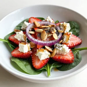 - 4 cups fresh baby spinach - 2 cups fresh strawberries - 1/2 cup crumbled feta cheese - 1/4 cup red onion - 1/4 cup slivered almonds - 3 tablespoons poppy seeds - 1/4 cup extra virgin olive oil - 3 tablespoons apple cider vinegar - 2 tablespoons honey or agave syrup - Salt and pepper to taste To create this amazing salad, you need fresh and colorful ingredients. Start with baby spinach. It's tender and packed with nutrients. Next, grab some strawberries. They add a sweet and juicy pop to every bite. Feta cheese gives a creamy touch. It balances the sweetness of the strawberries. Use crumbled feta from a block for the best texture. Red onion brings a sharp flavor. Slice it thin so it doesn't overpower the salad. Slivered almonds add a delightful crunch. Toast them if you want extra flavor and crispness. For the dressing, you need extra virgin olive oil. It adds richness. Then, use apple cider vinegar for a tangy twist. Honey or agave syrup sweetens the mix. Finish off with salt and pepper. These simple ingredients work together to create a vibrant and fresh salad. Each bite will burst with flavor. {{ingredient_image_2}} Start by making the dressing. In a small bowl, whisk together 1/4 cup of extra virgin olive oil, 3 tablespoons of apple cider vinegar, and 2 tablespoons of honey or agave syrup. Add salt and pepper to taste. Whisk until smooth. Set this aside. Letting the dressing sit allows the flavors to blend well. Next, grab a large salad bowl. Place 4 cups of fresh baby spinach in the bowl. Layer in 2 cups of sliced strawberries on top of the spinach. This adds a pop of color. Next, fold in 1/4 cup of thinly sliced red onion. Then sprinkle in 1/2 cup of crumbled feta cheese. Mix these ingredients gently to ensure an even flavor. Now it&rsquo;s time to dress the salad. Drizzle your prepared poppy seed dressing over the salad. Use gentle hands to toss everything together. This ensures every piece gets coated. For the final touch, sprinkle 1/4 cup of toasted slivered almonds and 3 tablespoons of poppy seeds on top. This adds a nice crunch and visual flair. Serve your salad right away for the best taste. Enjoy! To make your salad shine, start with picking ripe strawberries. Look for berries that are bright red with no white spots. They should feel firm but slightly soft when you press them. The smell is also key; ripe strawberries have a sweet aroma. When it comes to spinach, washing is vital. Rinse the baby spinach under cold water to remove dirt. Use a salad spinner or gently pat it dry with a clean cloth. This keeps the leaves crisp and fresh for your salad. If you want to mix things up, try different sweeteners in your dressing. You can use maple syrup instead of honey for a new flavor twist. Agave syrup is also a great choice. It has a mild taste that blends well. For the oil, you can swap olive oil for avocado oil. It adds a unique flavor and richness to the dressing. You might also try sesame oil for a nutty taste that pairs well with the salad. To add crunch, toast your slivered almonds. Place them in a dry pan over medium heat. Stir them often until they are golden brown. This process brings out their flavor and makes them even tastier. For variety, consider adding different toppings. You can sprinkle sunflower seeds or pumpkin seeds for more crunch. Fresh herbs like basil or mint can also add flavor and a pop of color to your salad. Pro Tips Freshness is Key: Use the freshest spinach and strawberries you can find to ensure maximum flavor and nutrient retention in your salad. Feta Cheese Tip: Crumbling the feta cheese from a block rather than using pre-crumbled cheese enhances the texture and flavor of the salad. Toasting Almonds: Lightly toasting the slivered almonds before adding them to the salad brings out their natural oils and intensifies their flavor. Let it Chill: Allow the assembled salad to sit in the refrigerator for 10 minutes before serving; this helps the flavors meld beautifully. {{image_4}} I love making this salad for everyone. For those who are vegetarian, this recipe is perfect as it uses no meat. You can enjoy the fresh taste of spinach and strawberries without any worries. If you need a gluten-free option, you can easily adapt this salad. The ingredients are already gluten-free. Just make sure any extras, like salad dressings, are also gluten-free. This way, everyone can enjoy the flavors. You can change this salad based on what fruit is fresh. In the summer, try adding blueberries or peaches. They add a nice twist to the taste. In fall or winter, you can swap spinach for kale or arugula. These greens give a different flavor while still being healthy and tasty. Adding fresh herbs can brighten the salad. Try using mint or basil for a fresh taste. They add a lovely aroma and flavor. For cheese lovers, you can switch feta for goat cheese or blue cheese. Each type brings its own rich flavor, making the salad unique. To store leftovers, place the salad in an airtight container. This keeps it fresh and tasty. For best results, eat the salad within 1-2 days. If you have dressing left, store it separately. This helps avoid soggy greens. Freezing this salad is not recommended. The spinach and strawberries will not hold up well. Instead, focus on how to store each ingredient. Keep spinach in a cool, dry place. Use a paper towel to absorb moisture. For strawberries, refrigerate them in a container. This prevents them from getting mushy. Store feta cheese in its brine for freshness. Almonds should stay in a sealed bag to keep their crunch. Poppy seeds can go in a cool, dark spot. This ensures all your ingredients stay fresh for your next salad. To make this salad vegan, swap the feta cheese for a plant-based alternative. There are many tasty vegan cheeses. You can also use avocado for creaminess. Instead of honey, use agave syrup or maple syrup for a sweet touch. These simple swaps keep the salad fresh and flavorful without any animal products. Yes, you can prepare this salad ahead of time! For best results, keep the dressing separate until serving. Store the salad without dressing in an airtight container in the fridge. It can last for 1-2 days. To keep the spinach crisp, avoid adding the dressing too early. Toss the salad with dressing just before you eat. This salad pairs well with many main dishes. Try serving it with grilled chicken or fish for a hearty meal. It also works great with roasted vegetables and quinoa for a veggie option. For a light lunch, serve it with a sandwich or wrap. The salad adds a fresh, zesty touch to any meal. This blog covered how to make a tasty Strawberry Spinach Poppy Seed Salad. You learned about fresh ingredients, step-by-step instructions, and helpful tips. Making this salad can be fun and easy. Try different fruits or dressings to find what you love most. It&rsquo;s versatile for any meal, too. Keep your salad fresh and enjoy every bite. Simple adjustments let you make it your own while keeping it healthy.