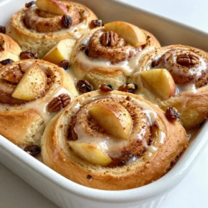 - 1 package (16 oz) refrigerated cinnamon roll dough - 2 medium apples, peeled, cored, and diced - 1 tablespoon fresh lemon juice - 1 teaspoon ground cinnamon - 1/4 cup packed brown sugar - 1/4 teaspoon ground nutmeg - 1/2 cup chopped pecans (optional) - 1/2 cup raisins (optional) - 1/2 cup icing (included in the cinnamon roll dough package or homemade) You can make this bake extra special with a few additions. Consider using: - Chopped nuts like walnuts or almonds for crunch. - Dried cranberries instead of raisins for a tart kick. - A sprinkle of vanilla extract for a fragrant twist. Choosing the right apples is key. I recommend using a mix of tart and sweet apples. Granny Smith apples add a nice tartness, while Fuji or Honeycrisp bring sweetness. Opt for fresh ingredients whenever possible. Fresh lemon juice brightens the flavors. If you have homemade icing, go ahead and use it! It can take your bake to the next level. {{ingredient_image_2}} First, preheat your oven to 350&deg;F (175&deg;C). This helps the bake cook evenly. Next, grab a 9x13-inch baking dish. Lightly grease it with butter or non-stick spray. This step is key to keeping your bake from sticking. In a medium bowl, add the diced apples. Pour the fresh lemon juice over them. This juice keeps the apples from browning. Now, sprinkle in the ground cinnamon, brown sugar, and nutmeg. Mix gently until the apples are well-coated. If you want more flavor, add chopped pecans and raisins. They give extra crunch and sweetness. Open your package of cinnamon roll dough. Carefully separate each roll and cut them into quarters. This makes bite-sized pieces. Spread half of these pieces in the bottom of your greased dish. This is your first layer. Next, spoon the apple mixture over these cinnamon rolls. Spread it out evenly. Then, place the remaining cinnamon roll pieces on top of the apples. Make sure they cover the apples well. Now, it&rsquo;s time to bake. Place the dish in your preheated oven. Bake for 25-30 minutes. Look for golden brown tops and bubbling filling. Ovens can differ, so keep an eye on it. You want it to be just right. Once baked, remove the dish from the oven. Drizzle the icing from the cinnamon roll package over the warm bake. Let the icing melt into the rolls. This adds a sweet touch. Wait about 5-10 minutes before serving. This cooling time helps the flavors mix. For a fun twist, serve warm in bowls. You can add a scoop of vanilla ice cream or a sprinkle of powdered sugar on top. Enjoy your delicious creation! To dice apples well, start with firm apples. I use a sharp knife for this task. First, cut off the top and bottom to create a flat surface. Then, slice the apple into quarters. Remove the core and seeds. Next, lay each quarter flat and cut it into thin strips. Finally, rotate the strips and chop them into small cubes. This method gives you even-sized pieces. It helps the apples cook evenly in your bake. For a flakier texture, use cold ingredients. Cold butter helps create layers in the dough. When mixing your apple filling, avoid over-mixing. Keep the apples chunky for a nice bite. You can also add a sprinkle of flour to the cinnamon roll pieces. This helps absorb excess moisture and keeps everything light. Baking at the right temperature is key. Make sure your oven is fully preheated to 350&deg;F (175&deg;C) before baking. Icing your bake right after it comes out of the oven makes a big difference. I recommend using the icing from the cinnamon roll package. If you prefer homemade icing, make it while your bake is in the oven. Drizzle the icing generously over the warm bake. This allows it to melt and soak into the rolls. For a fun twist, add a dash of vanilla extract to your icing. It gives extra flavor that complements the apples and cinnamon so well. Pro Tips Use Fresh Apples: For the best flavor and texture, choose crisp, tart apples like Granny Smith or Honeycrisp. They hold up well during baking and complement the sweetness of the cinnamon rolls. Customize Your Add-ins: Feel free to experiment with additional ingredients such as dried cranberries, walnuts, or even a touch of caramel sauce for extra indulgence. Tailor the recipe to your taste! Monitor Baking Time: Since oven temperatures can vary, keep an eye on your bake during the last few minutes. You want a golden-brown top and bubbling filling, but avoid over-baking to keep it moist. Serve Warm: This dish is best enjoyed warm. Consider reheating leftovers in the microwave for a few seconds or in the oven to bring back that freshly baked taste. {{image_4}} You can switch out apples for other fruits. Pears work well for a sweet twist. Peaches add a fresh, juicy taste. Berries bring a bright color and flavor. Try using a mix of these fruits to keep it exciting. Each option gives a unique taste to the bake. For a gluten-free version, look for gluten-free cinnamon roll dough. Many brands now offer this option. You can find it at stores or make your own. Use gluten-free flour blends to keep the texture right. This way, everyone can enjoy this yummy treat without worry. Nuts can add crunch and flavor. Walnuts or almonds are great swaps for pecans. If you want a warm taste, try adding cardamom or ginger. These spices mix well with cinnamon. Experimenting with different flavors makes each bake a new adventure. After enjoying your Apple Cinnamon Roll Bake, you might have leftovers. To keep them fresh, place the cooled bake in an airtight container. Make sure it is sealed tightly. Store it in the fridge for up to three days. For best taste, eat it within two days. This helps keep the flavors vibrant. When you are ready to enjoy your leftovers, reheating is key. Preheat your oven to 350&deg;F (175&deg;C). Place the bake in an oven-safe dish. Cover it loosely with foil. Heat it for about 10 to 15 minutes. This method warms the dish evenly. You can also use the microwave. Heat a single serving for about 30 seconds to 1 minute. Check to see if it&rsquo;s warm enough. If you want to save your Apple Cinnamon Roll Bake for later, freezing is a great option. First, let the bake cool completely. Then, cut it into portions. Wrap each piece tightly in plastic wrap. Place the wrapped pieces in a freezer bag. Label the bag with the date. You can freeze it for up to three months. When you&rsquo;re ready to eat, thaw it in the fridge overnight. Reheat as mentioned above for the best taste. Yes, you can use homemade cinnamon rolls. Just make sure they are soft and fluffy. Cut them into small pieces like the store-bought dough. This will help them mix well with the apples. Homemade rolls can add a special touch to your bake. To serve more people, simply double the recipe. Use a larger baking dish, like a 12x18-inch pan. Make sure to keep the baking time similar. Check for doneness by looking for golden brown tops. If needed, adjust the time by a few minutes. Serve the bake warm for the best taste. Use individual bowls for a nice touch. You can add a scoop of vanilla ice cream on top for extra flavor. A light dusting of powdered sugar makes it look fancy. Enjoy it with family or friends! This article covered how to make a delicious Apple Cinnamon Roll Bake. We reviewed the key ingredients and optional add-ins to enhance flavor. I guided you through step-by-step instructions for preparing and baking. You also learned useful tips for perfecting texture and icing. Plus, we explored tasty variations to suit your taste. In conclusion, this dish is simple and fun to make. Enjoy your bake warm, and share it with others!