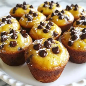 - 3 ripe bananas, thoroughly mashed - 1/3 cup melted coconut oil (or vegetable oil) - 1/2 cup packed brown sugar - 1 large egg, beaten well - 1 teaspoon pure vanilla extract - 1 teaspoon baking soda - A pinch of salt - 1 teaspoon ground cinnamon - 1 1/2 cups all-purpose flour - 1 cup semi-sweet chocolate chips - 1/2 cup chopped walnuts (optional) You need a few simple ingredients to make these tasty muffins. Start with 3 ripe bananas. They should be soft and sweet. The bananas give flavor and moisture. Next, use 1/3 cup of melted coconut oil. You can also use vegetable oil. It helps keep the muffins soft. Add 1/2 cup of packed brown sugar. This sweetens the muffins and adds a rich taste. You will need 1 large egg, beaten well. The egg helps bind everything together. Don&rsquo;t forget 1 teaspoon of pure vanilla extract. This adds a nice, sweet aroma. Next, add 1 teaspoon of baking soda. This makes the muffins rise. Include a pinch of salt to enhance the flavors. You&rsquo;ll need 1 teaspoon of ground cinnamon for a warm spice touch. Use 1 1/2 cups of all-purpose flour. This is the main base for the muffins. For a sweet finish, add 1 cup of semi-sweet chocolate chips. They melt and add gooey goodness. Lastly, if you like, include 1/2 cup of chopped walnuts. They add crunch and extra taste. Gather these ingredients, and you're ready to make some delicious muffins! {{ingredient_image_2}} 1. Preheat your oven to 350&deg;F (175&deg;C). This ensures even baking. 2. Prepare your muffin tin by lining it with paper liners. You can also lightly grease it with cooking spray to prevent sticking. 3. In a large bowl, mash the ripe bananas well. 4. Add the melted coconut oil to the mashed bananas. Mix until smooth and well combined. 5. Now, add the packed brown sugar to the banana mixture. Stir until the sugar is evenly mixed in. 1. Sprinkle in the baking soda, pinch of salt, and ground cinnamon. Mix these dry ingredients into the batter gently. 2. Gradually add the all-purpose flour. Stir just until you no longer see the flour. Avoid over-mixing; this keeps your muffins light and fluffy. 1. Carefully fold in the semi-sweet chocolate chips. If you like, add the chopped walnuts for extra crunch. 2. Spoon the batter into the prepared muffin cups, filling each about 3/4 full. This allows the muffins to rise without overflowing. 3. Place the muffin tin in the preheated oven. Bake for about 18-22 minutes. They are done when a toothpick comes out clean or with a few moist crumbs. 4. Once baked, let the muffins cool in the tin for about 5 minutes. Then, transfer them to a wire rack to cool completely. To make great muffins, avoid over-mixing the batter. When you mix too much, the muffins can become tough. Mix just until the flour disappears. This keeps your muffins light and fluffy. Prepare your muffin tin well. You can line it with paper liners or use cooking spray. This helps prevent the muffins from sticking. It also makes for easy cleanup after baking. You can swap coconut oil for vegetable oil if needed. Both oils work well and keep the muffins moist. You can also use unsalted butter instead for a different flavor. If you want to change the sweetness, try using maple syrup or honey. These sweeteners add a unique taste. Just remember to reduce the flour slightly to keep the right texture. Serving your muffins on a decorative platter makes them look special. You can dust them lightly with powdered sugar for a nice touch. Serve the muffins warm, with a small dish of butter or honey. This adds an extra layer of flavor. It makes for a delightful treat that everyone will enjoy. Pro Tips Use Ripe Bananas: The riper the bananas, the sweeter and more flavorful your muffins will be. Look for bananas with lots of brown spots for the best results. Don&rsquo;t Overmix: Mix the batter just until the flour is incorporated. Overmixing can lead to dense muffins, so keep it gentle! Customize Your Add-ins: Feel free to add other mix-ins like dried fruit or different nuts to create your own unique flavor combinations. Check for Doneness: Every oven is different, so start checking your muffins a couple of minutes before the suggested baking time to ensure they don&rsquo;t overbake. {{image_4}} You can change the flavor of your muffins easily. Try different nuts beyond walnuts. Pecans or almonds add a nice crunch. You can even skip the nuts if you want. Other chocolate types can also change the taste. Use dark chocolate chips for a richer flavor. White chocolate can give a sweet twist. Mix and match to find your favorite. If you need gluten-free muffins, use gluten-free flour. Look for blends made for baking. They work great in this recipe. You won&rsquo;t lose flavor or texture. For vegan muffins, swap the egg with a flaxseed meal. Mix one tablespoon of flaxseed with three tablespoons of water. Let it sit for a few minutes until it thickens. You can also use a plant-based milk in place of coconut oil. As the seasons change, so can your muffins. Try adding pumpkin puree for a fall treat. It keeps the muffins moist and adds flavor. Applesauce is another great option. It gives a sweet taste and reduces fat. You can also play with spices. In fall, add nutmeg or ginger for warmth. In spring, use lemon zest for a fresh touch. Each season can bring a new twist to your banana bread muffins! Store your muffins at room temperature in an airtight container. They stay fresh for about 3 days. If you want to keep them longer, put them in the fridge. Make sure to wrap them well in plastic wrap. This helps keep them moist. To freeze muffins, let them cool completely first. Place each muffin in a freezer bag or wrap them in foil. Make sure to squeeze out all the air before sealing. They can stay frozen for up to 3 months. When you want to eat them, take the muffins out of the freezer. Put them in the fridge overnight to thaw. You can also leave them at room temperature for a few hours. For reheating, use the oven for the best results. Preheat your oven to 350&deg;F (175&deg;C). Place the muffins on a baking sheet and heat them for about 10 minutes. This keeps them soft and warm. If you're in a hurry, you can use the microwave. Heat each muffin for about 15 to 20 seconds. Just be careful, as they can become chewy if you heat them too long. Enjoy your delicious muffins! How ripe should bananas be for the best flavor? You want your bananas to be very ripe. Look for brown spots on the skin. The more spots, the sweeter the bananas. This helps the muffins taste great and stay moist. Can I make the muffins without eggs? Yes, you can make these muffins without eggs. Use 1/4 cup of unsweetened applesauce instead. This keeps the muffins moist and adds a bit of sweetness. How do I know when the muffins are done baking? Check the muffins at 18 minutes. Insert a toothpick into the center. If it comes out clean or with a few crumbs, your muffins are done. If it&rsquo;s wet, bake for a few more minutes. What to do if the muffins are undercooked? If your muffins are undercooked, return them to the oven. Bake them for an extra 2-5 minutes. Keep checking with a toothpick until it comes out clean or with a few moist crumbs. Can I use different types of chocolate chips? Yes! You can use milk chocolate, dark chocolate, or even white chocolate chips. Each type will change the flavor a bit. Choose what you love best. How can I make these muffins healthier? To make them healthier, try using whole wheat flour instead of all-purpose flour. You can also reduce the sugar by using less brown sugar or adding mashed fruit like applesauce. In this post, I shared a simple recipe for tasty chocolate banana muffins. You learned about the key ingredients, step-by-step instructions, and helpful tips for perfect results. I also covered fun variations and how to store your muffins well. Baking can be fun and rewarding. Enjoy making these muffins with your family. You&rsquo;ll love the sweet smell and delicious taste. Try them today and get creative with your own flavors!